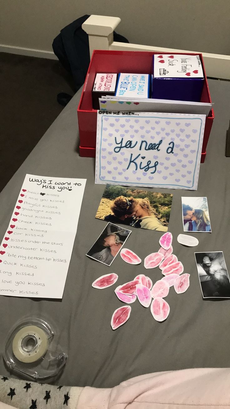 a table topped with pictures and cards on top of a bed