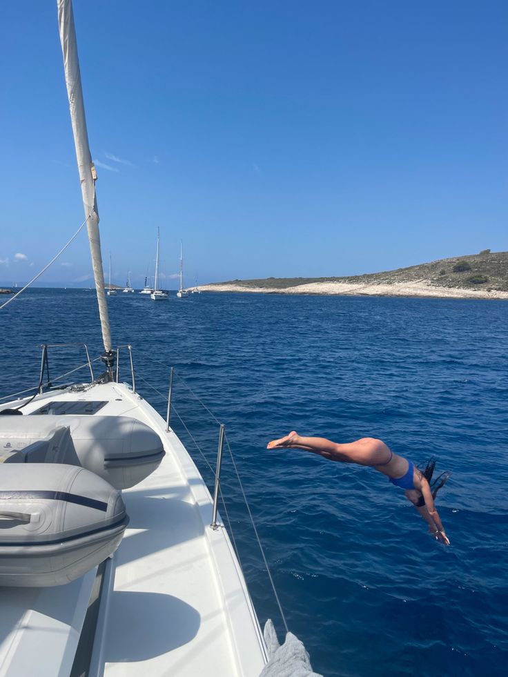 a person diving into the ocean from a boat