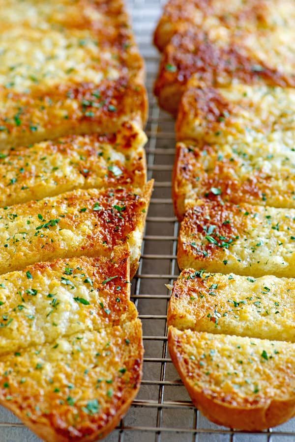 several slices of pizza sitting on top of a cooling rack covered in cheese and parmesan