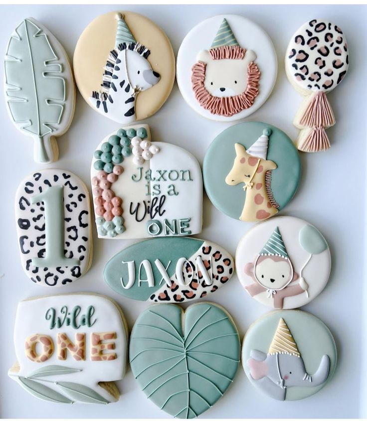 decorated cookies are arranged in the shape of animals and letters, including one for each child's first birthday