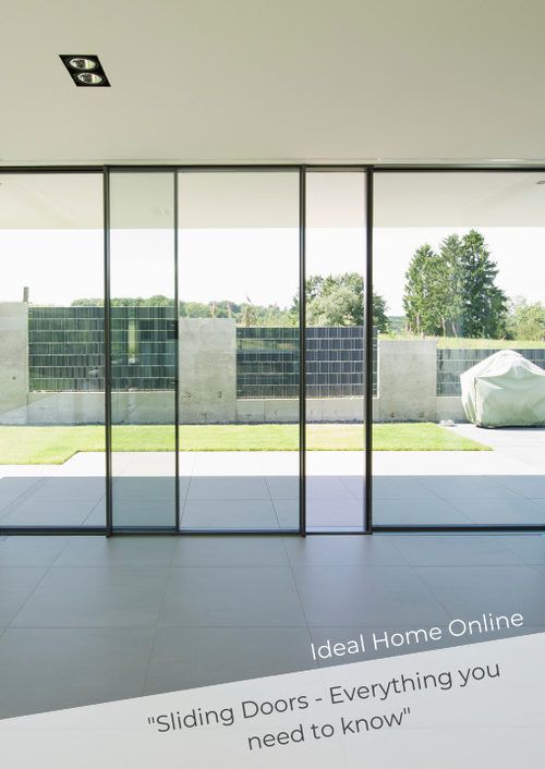 an empty room with glass walls and sliding doors