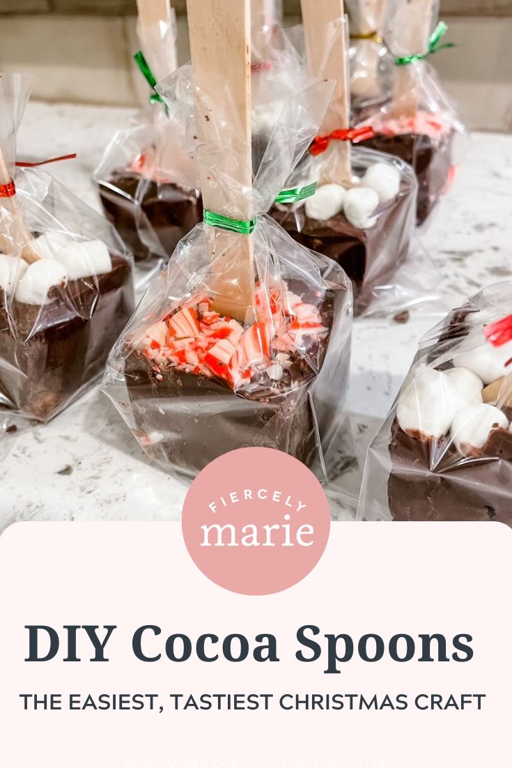 chocolate spoons with marshmallows and candy on them in plastic wrappers