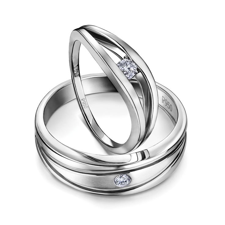 two white gold wedding rings with diamonds on each one and the other in between them