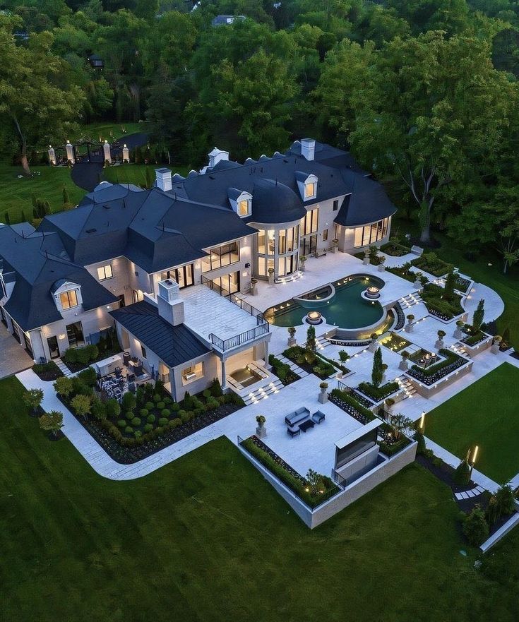 an aerial view of a large home in the evening