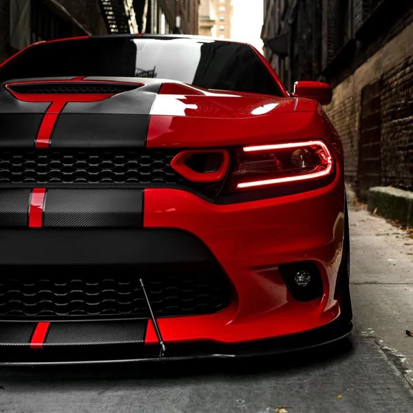 the front end of a red and black sports car