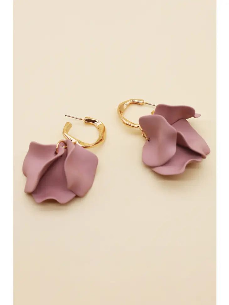 two pairs of earrings with pink flowers hanging from them on a white surface, one is gold and the other is purple