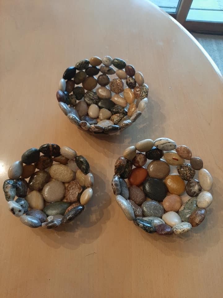 three bowls filled with rocks sitting on top of a table