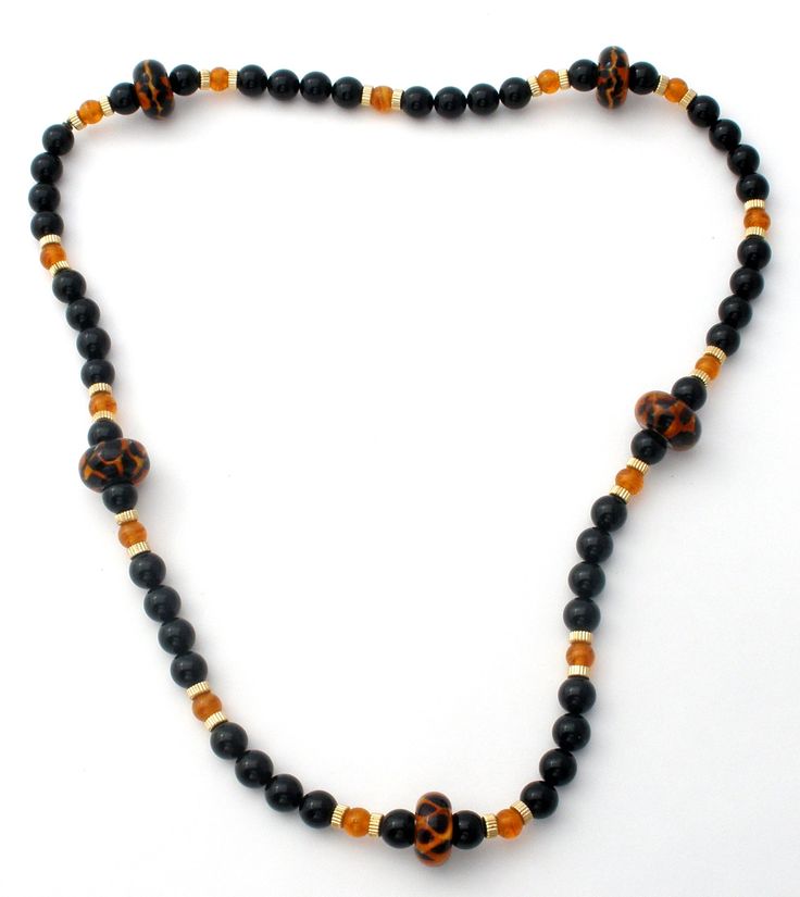 Vintage Beaded Jewelry - This is a stylish black onyx bead necklace with amber art glass and gold plated spacers. It is 28" long, gemstones are .38" (10mm) and the art glass beads are slightly over .75 (29mm), weighs 111 grams. Luxury Amber Beaded Necklaces With Oval Beads, Luxury Amber Beaded Necklaces With Gemstone, Amber Necklaces With Polished Oval Beads, Antique Amber Necklaces With Polished Beads, Luxury Hand-strung Amber Beaded Necklaces, Onyx Bead, Bead Necklace, Black Onyx, Art Glass