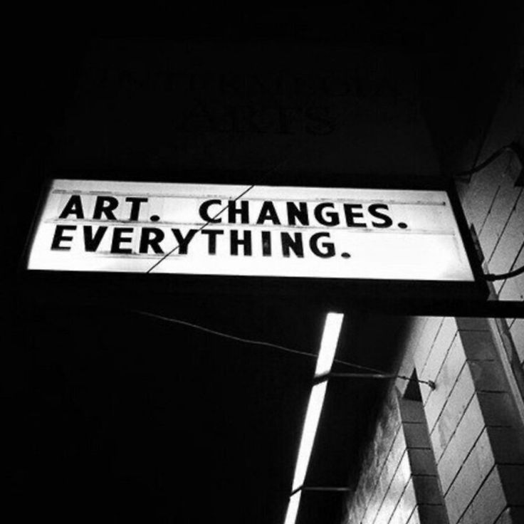 a black and white photo of a street sign that says art changes everything on it