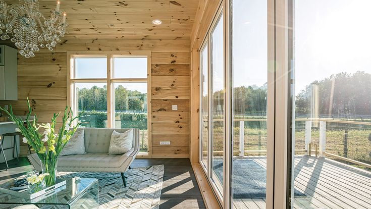 a living room filled with furniture next to a window covered in frosty glass doors