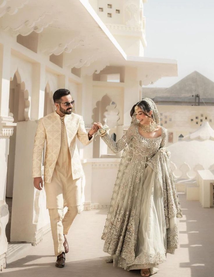 a man and woman dressed in wedding attire