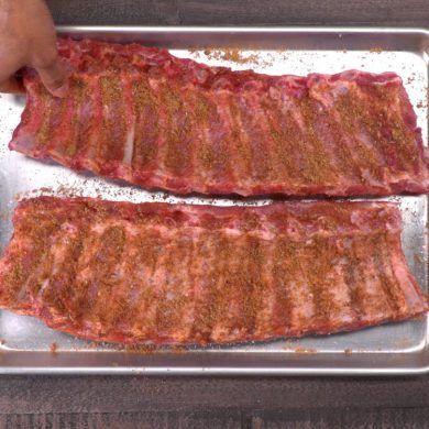 two pieces of meat sitting on top of a metal pan