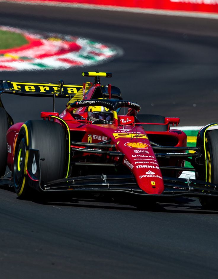 a red racing car driving on a race track