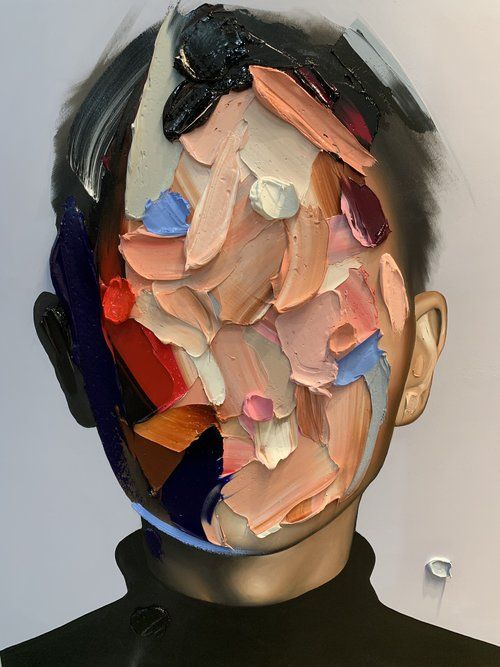 a man's head is covered in multicolored pieces of paper and plastic