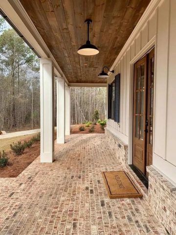 the front porch is lined with brick and wood