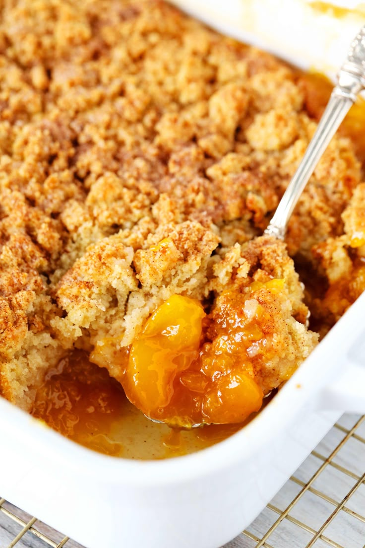 a close up of a casserole dish with peaches and crumbs