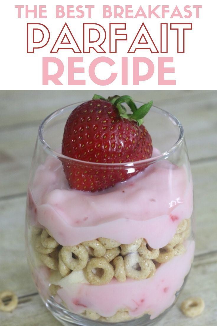 a strawberry sitting on top of a dessert in a glass bowl with cereal and pretzels