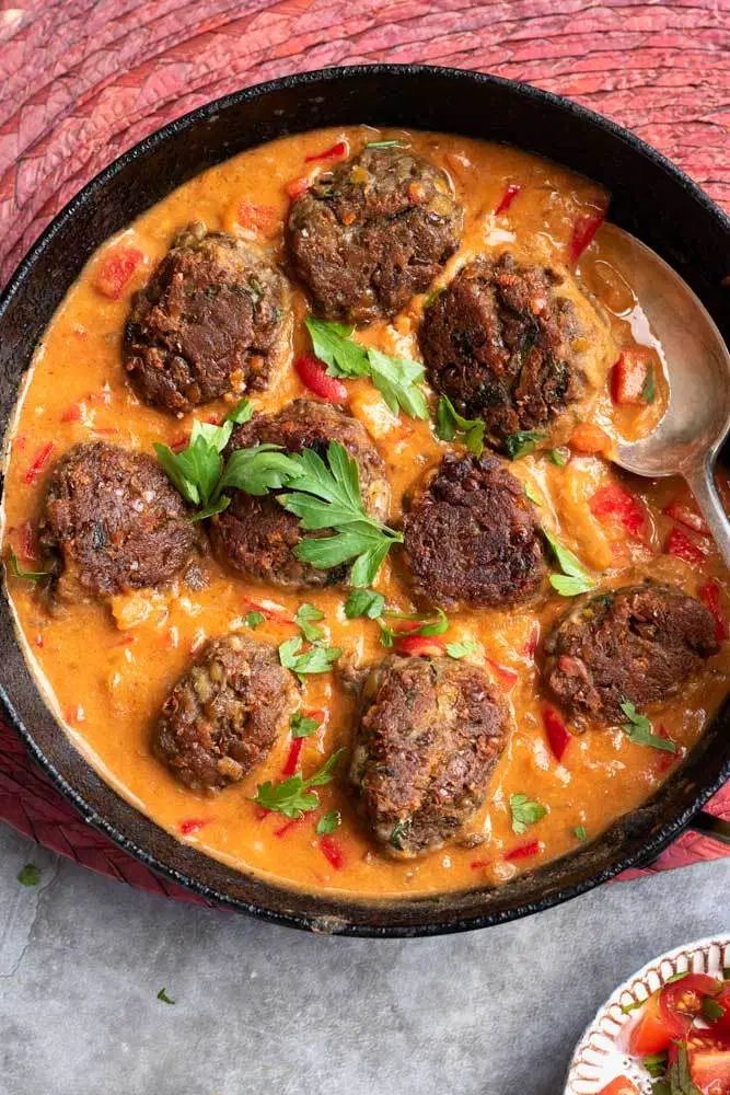 some meatballs and sauce in a pan on a table