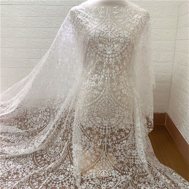 Heavy embroidered lace fabric with an amazing design and high quality about that product Dimensions Length: 1 Yards; Width: 51 Inches Primary fabric: Tulle Primary fiber: Polyester Secondary fiber: Polyester Color: off-white ❀❀ About the sample❀❀ If you need to check the quality and pattern of the lace fabric, we can provide you with a small sample; when you confirm the order, we will refund the sample fee for you. Perfect for dress making, bridal wear, wedding gown, bodice or curtains ❀❀ MEASUR Embroidered Wedding Gown, Pallas Couture, White Lace Fabric, Beaded Lace Fabric, Bridal Lace Fabric, Tulle Flowers, Embroidered Lace Fabric, Wedding Dress Fabrics, Embroidered Wedding