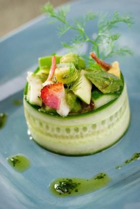 a plate with some food on top of it and green stuff in the middle of it