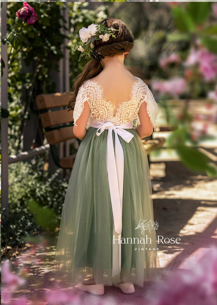 Our whimsical style Flower Girl dress features a soft stretch lace bodice and a feathered lace V-back with flutter sleeves. Beautiful for your flower girls. Optional custom wedding sashes. Dress has soft white lace bodice with lovely sage tulle skirt. Shown with White Sash. *Custom Color Dresses are available for orders of 8 dresses or more. Choose Dress Size and Sash Options, then leave sash color in cart notes box. Sage Green Flower Girl Dress, Flower Girl Dress With Sleeves, Full Length Tulle Skirt, Flower Girl Dress Boho, Boho Flower Girl Dress, Green Flower Girl Dresses, Burgundy Flower Girl Dress, Dance Portraits, Vintage Flower Girls