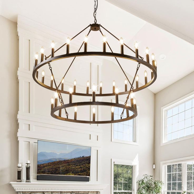 a chandelier hanging from the ceiling in a living room with fireplace and windows