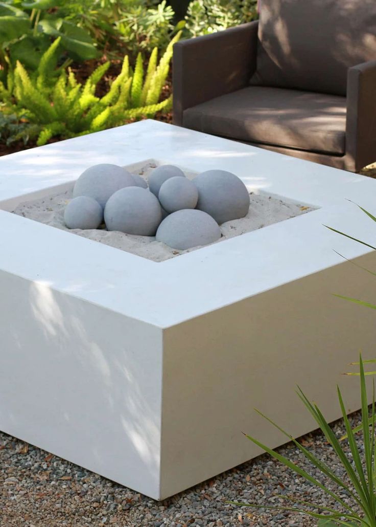 an outdoor fire pit with rocks in it