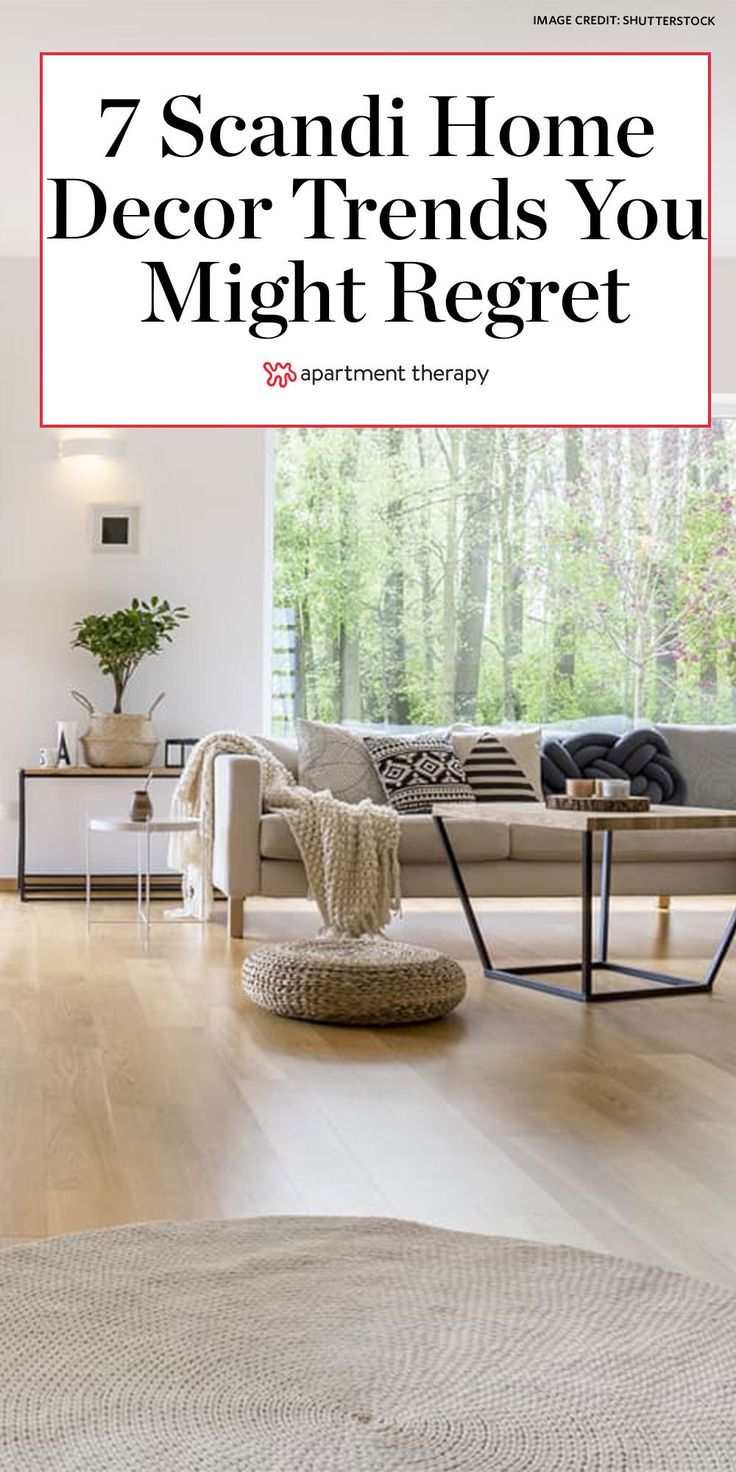 a living room filled with furniture and a large white rug on top of a hard wood floor