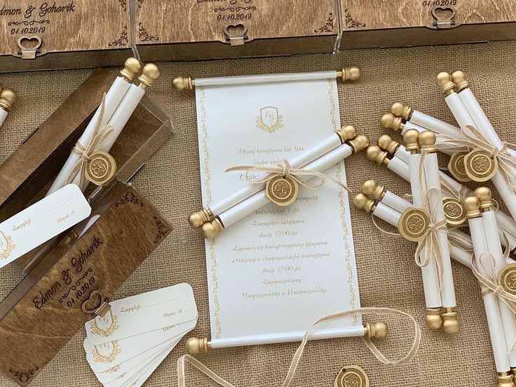 the wedding stationery is laid out on top of burlocks and twine