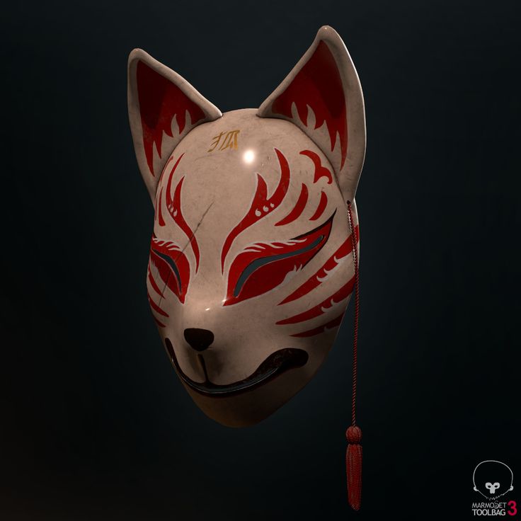 an animal mask with red and white designs on it's face, hanging from a string