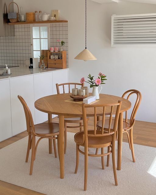 a dining table with four chairs around it