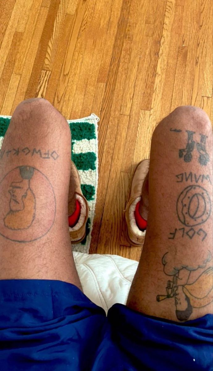 two people with tattoos on their legs and feet