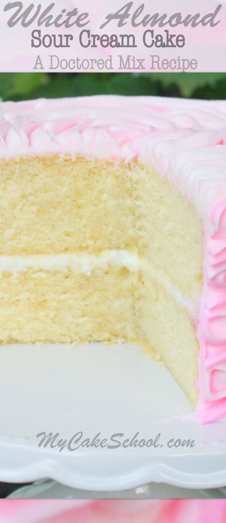 a white cake with pink icing on a plate