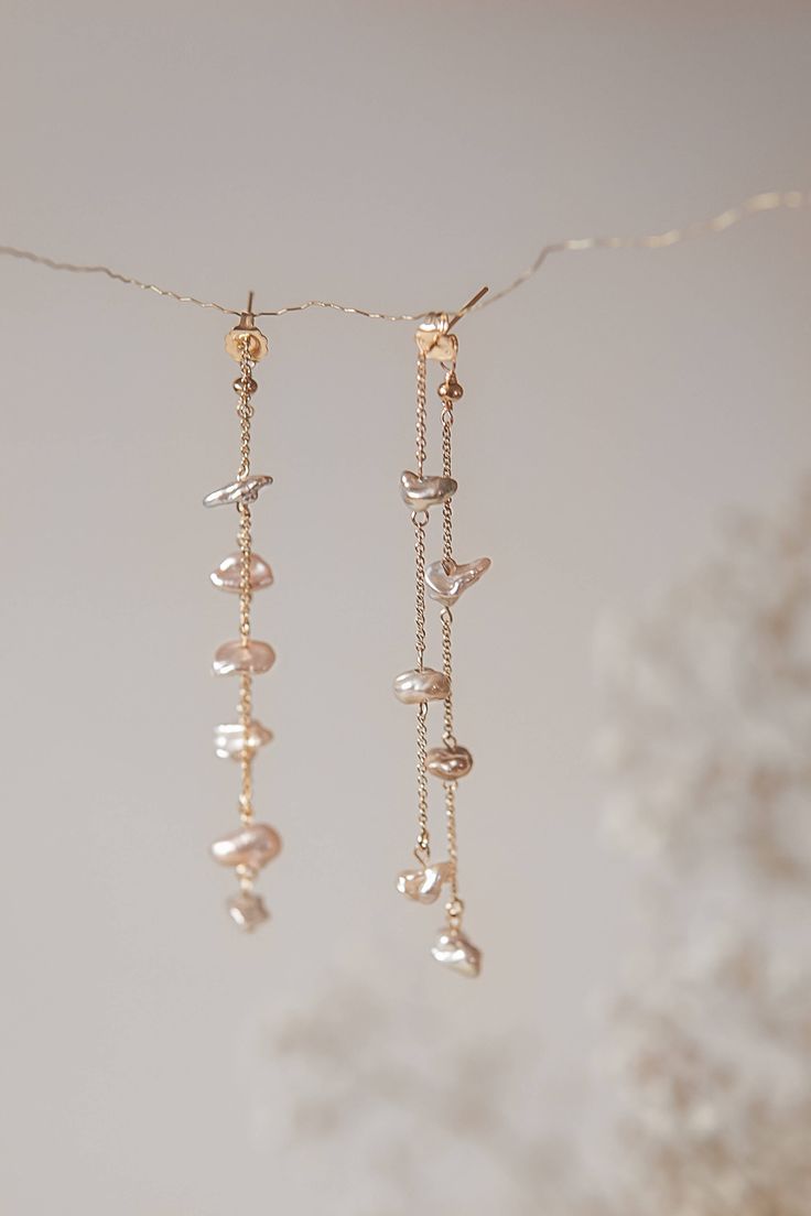 These handcrafted earrings feature two rows of Freshwater Pearls, each individually wrapped and suspended from a 14k 8cm gold-filled chain and secured with butterfly backings. Pair with the Safia necklace for a complete and coordinated look. Please note that, as we use only natural pearls, there may be slight variations in shape and shade. All our jewelry comes with a one-year guarantee valid from the date of delivery. Freshwater Pearl Earrings, Freshwater Pearls Earrings, Homemade Jewelry, Jewelry Lookbook, Handcrafted Earrings, Bijoux Diy, Jewelry Inspo, Pretty Jewellery, Natural Pearls