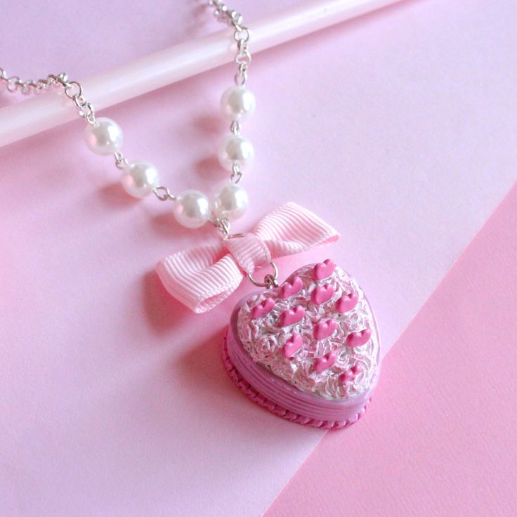 Some of my personal favorite pieces that I've ever made have always included miniature cakes! That's why I'm so excited to reveal this new limited edition Pink Heart Miniature Cake! It's like everything I've always been obsessed with in miniature wearable form: Pink, pastels, hearts, frosting, birthday cakes, 90s barbie vibes, valentine's aesthetic.This miniature cake is so detailed you might think it is real! Includes so many cute details like heart shape, pink frosting, piped pastel frosting a Pink Heart-shaped Kawaii Jewelry, Pink Kawaii Heart-shaped Jewelry, Whimsical Pastel Jewelry As Gift, Pink Polymer Clay Birthday Jewelry, Pastel Handmade Jewelry Gift, Sweet Pink Jewelry With Heart Beads, Handmade Pastel Jewelry For Gifts, Cute Pastel Jewelry For Gifts, Cute Pastel Jewelry For Gift