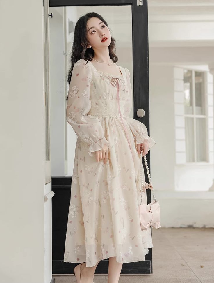 Lightweight silky chiffon printed midi dress with a square neckline, long sheer puff sleeves, tie-up lace neck and laced waistline. Concealed back zipper. Lined. S: 33" chest, 26.5" waist, 43" lengthM: 34.5" chest, 28" waist, 43" lengthL: 36" chest, 29.5" waist, 43.5" lengthXL: 37.5" chest, 31" waist, 43.5" length Chic Lace Midi Dress With Square Neck, Chic Midi Dress With Lace Trim And Square Neck, Feminine Chiffon Dress With Square Neck, Beige Lantern Sleeve Dress For Spring, Spring Chiffon Dress With Sheer Long Sleeves, Cream Lantern Sleeve Dresses For Spring, Feminine Chiffon Midi Dress For Daywear, Elegant Chiffon Dress With Square Neck For Garden Party, Elegant Square Neck Chiffon Dress For Garden Party