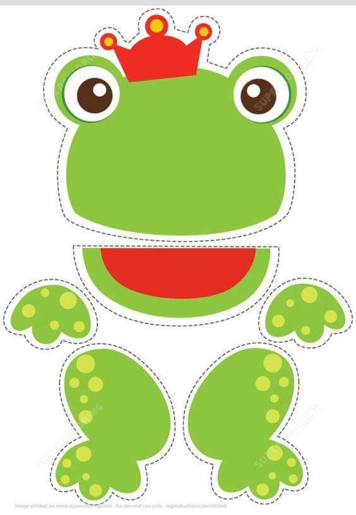 a cut out frog with a crown on it's head and eyes, sitting down