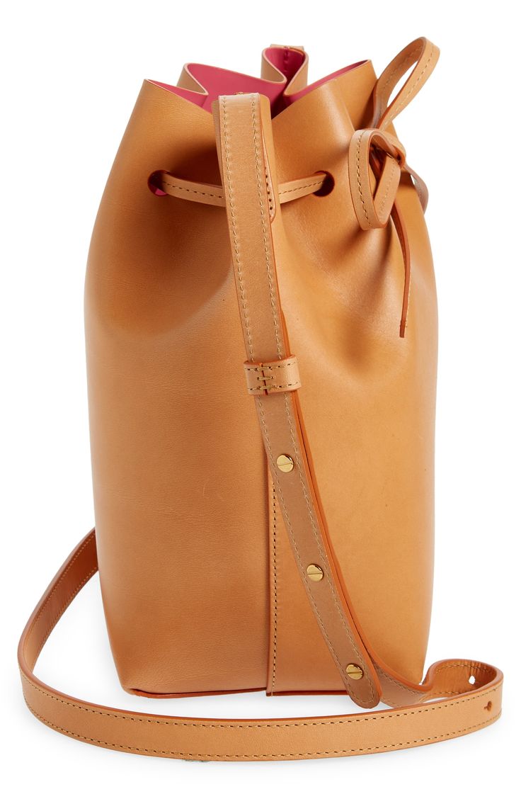 A coated, matte-patent lining creates colorful contrast on this bucket bag made from vegetable-tanned Italian leather that develops a rich patina over time. Drawstring closure Adjustable push-stud strap Natural colorways will darken over time Patent-leather lining Leather Made in Italy Designer Handbags Mansur Gavriel, Leather Bucket Bag, Leather Bucket, Italian Leather, Bag Making, Designer Handbags, Bucket Bag, Patent Leather, Patina