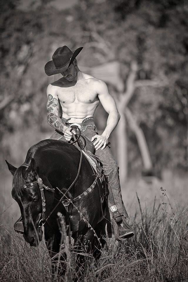 a shirtless man riding on the back of a horse