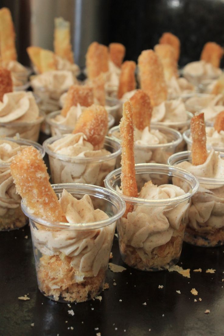 small cups filled with desserts sitting on top of a table