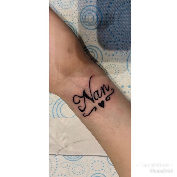 a woman's foot with the word mary tattooed on her left ankle and heart