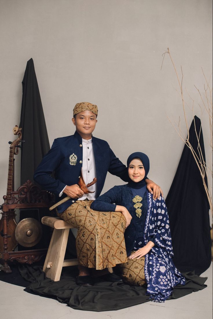 a man and woman pose for a photo in front of an old - fashioned sewing machine