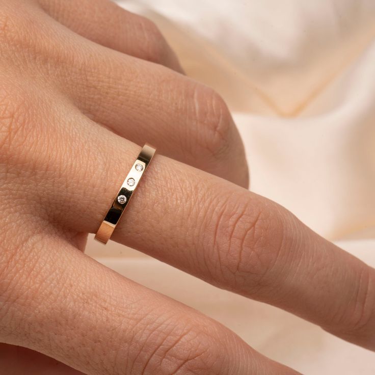 Fall in love with our 14k Flat Diamond Band .04CTW Classy and timeless. The perfect gift for that special someone, or simply as a reminder to love yourself. Featuring 3 Genuine ethically sourced 1.5mm diamonds Band thickness: 2.5mm Material: 14k Gold and Genuine Diamonds 14k Gold Bands With Diamond Accents, Yellow Gold Sterling Silver Wedding Rings With Diamond Accents, White Gold Promise Jewelry Stamped 14k, White Gold 14k Stamped Promise Jewelry, Minimalist Diamond Bands For Anniversary, Modern 14k Gold Promise Bands, 14k Gold Wedding Band With Diamond Accents, Minimalist Diamond Anniversary Bands, 14k Gold Stackable Rings With Diamond Accents For Promise