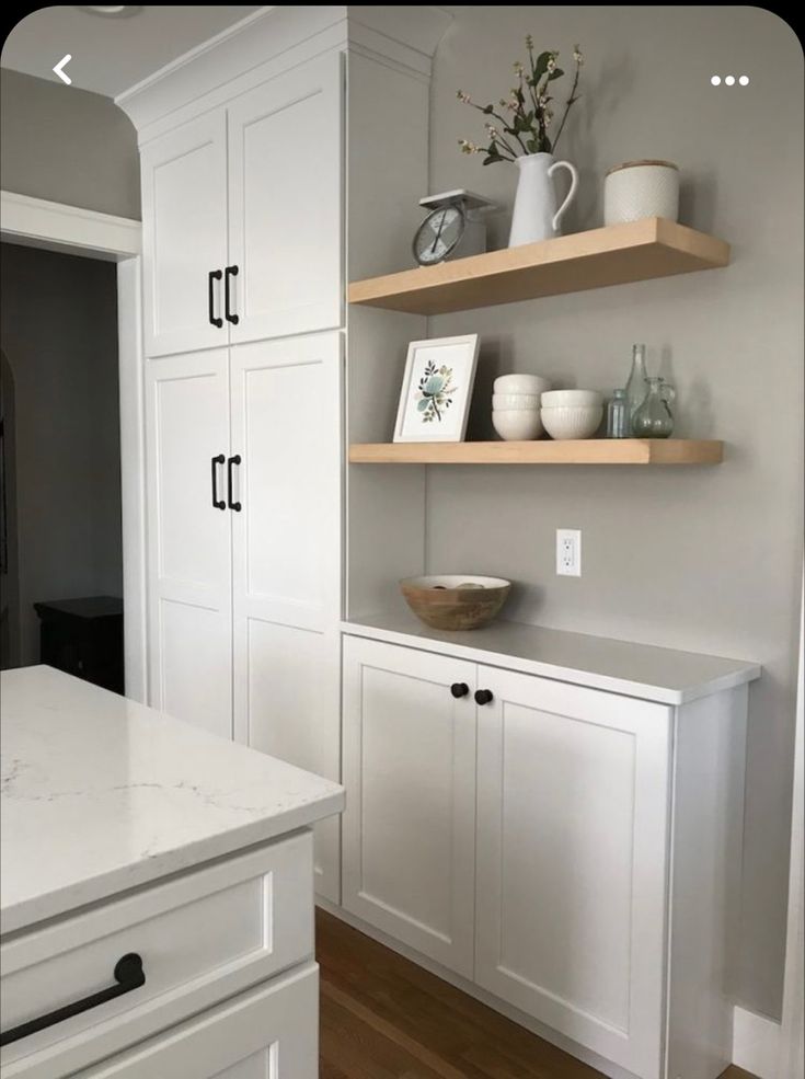 the kitchen is clean and ready to be used for cooking or baking, with white cabinets