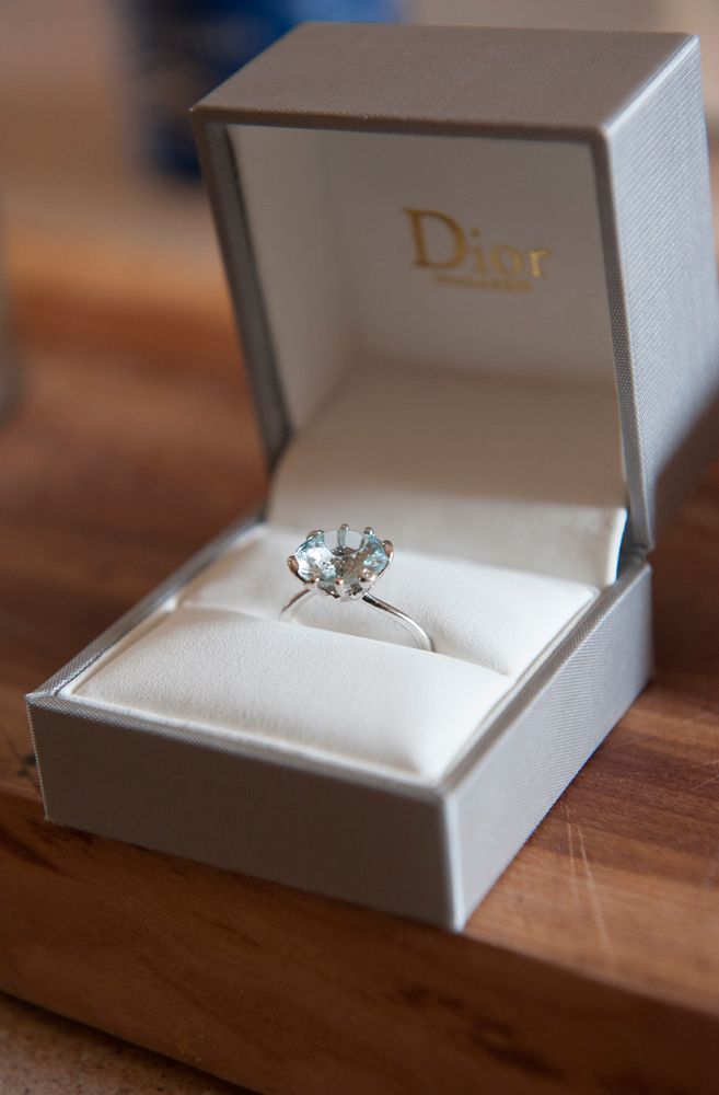 an engagement ring in a box on a table