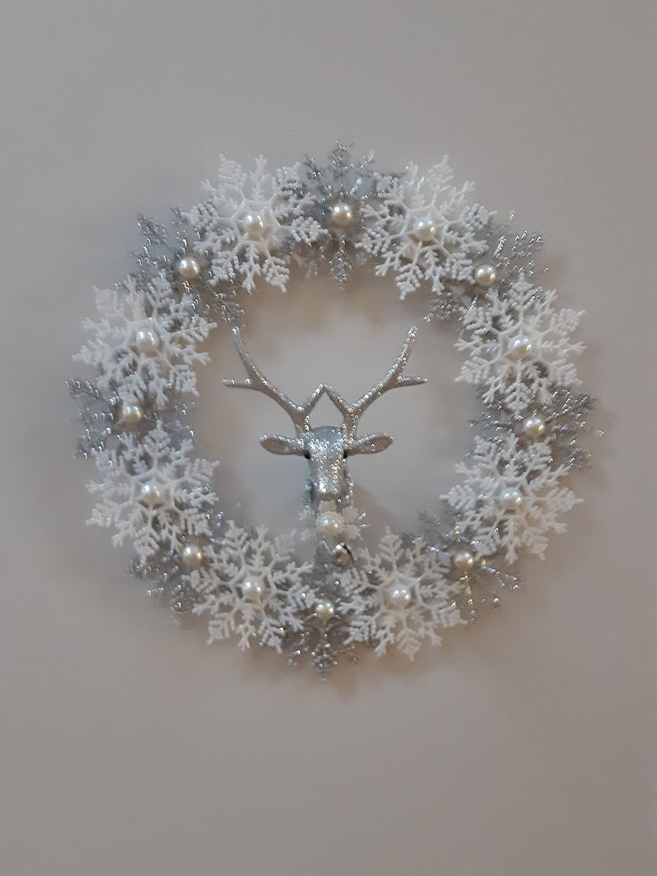 a christmas wreath with a deer head and snowflakes