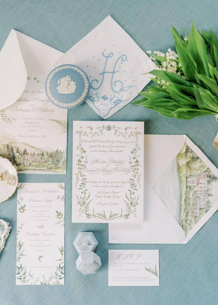 the wedding stationery is laid out on top of each other, including an envelope