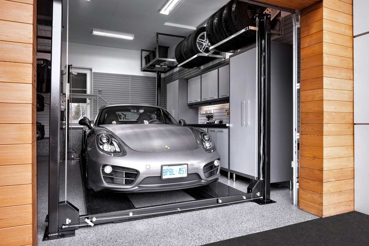 a car is parked in the garage with its door open