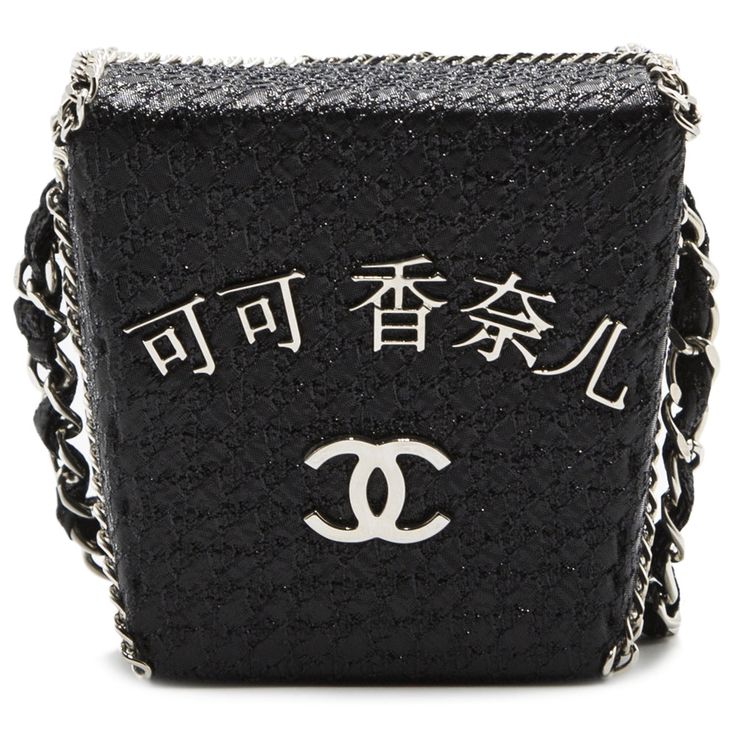 This Limited Edition and extremely sought-after Take Away Box bag from the Chanel Shanghai Accessories Runway Collection is crafted from a combination of black lambskin leather and metallic fabric. Both exuberant and whimsical, the piece features the signature CC logo plaque embossed in silver-tone metal hardware at the front, a chain-link trim and the iconic Chanel silver metal strap. The four top flaps of the bag are sealed by a magnetic closure but open to reveal a spacious black leather inte Modern Party Bags With Silver-tone Logo Plaque, Luxury Silver Rectangular Box Bag, Luxury Rectangular Bag With Silver-tone Logo Plaque, Luxury Silver Box Bag, Designer Rectangular Box Bag With Silver-tone Hardware, Chic Rectangular Bags With Silver-tone Logo Plaque, Luxury Black Shoulder Bag With Silver-tone Logo, Silver Rectangular Textured Leather Shoulder Bag, Silver Textured Leather Rectangular Shoulder Bag