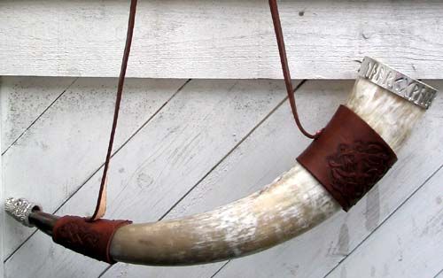 a cow horn hanging from the side of a building